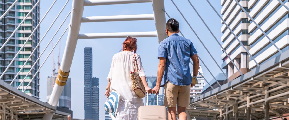 Young asian couple walking with luggage travel summer vacation o Young asian couple walking with luggage travel summer vacation or honeymoon trip